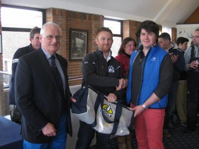 Jack Neale, the winning helm on J/80 Boysterous, in the Academy Frostbite Series receives his prize from Neil 'Jaffa' Harrison, Doyle Sails, and left Commodore Chris Mansfield © Peta Stuart-Hunt